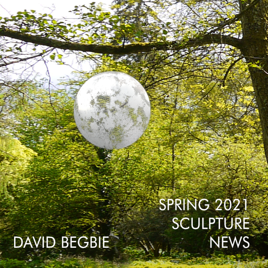 A moon sculpture is suspended in a garden as a preview to a spring 2021 newsletter