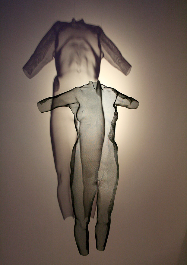 A black transparent figure suspended with distorted shadow projection