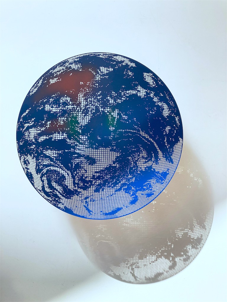 Limited edition sculpture of our blue planet, a blue-painted floating artwork.